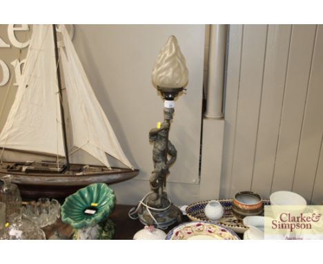 A Spelter table lamp in the form of a Centurion with flambé shade 