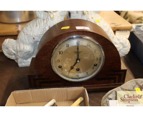 An oak cased chiming mantel clock by Salisbury &amp; Sons Guildford