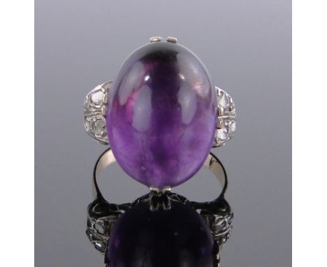 A Large cabachon amethyst set ring,diamond set shoulders, unmarked gold settings, amethyst height 20 mm, size R