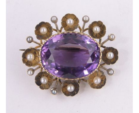 An amethyst & pearl set oval brooch,unmarked gilt metal settings, length 30 mm