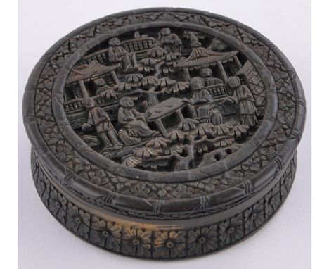 A 19th century Chinese relief carved horn snuff box,decorated with figures, buildings & blossom trees, 3.5" across