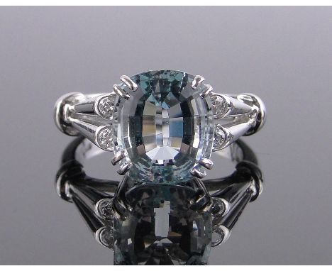 An 18 ct white gold cushion cut aquamarine ring,aqua height 10.5 mm with 4 diamond set shoulders, size O