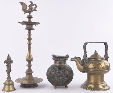 A group of Middle Eastern brass items,including a large Indian brass oil lamp height 20", a relief cast swing handled pot (4)