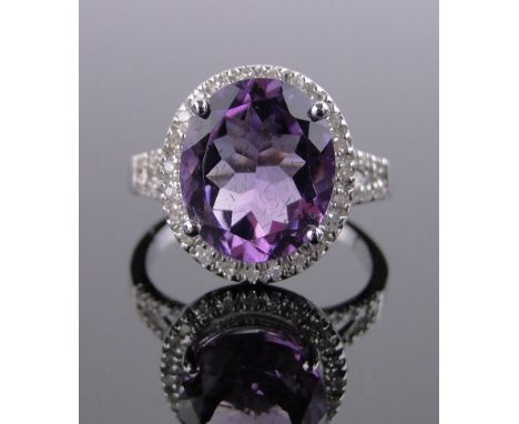 A 14 ct white gold amethyst & diamond cluster ring,amethyst approx 5.8 carats diamond content approx 0.5 carats, setting heig