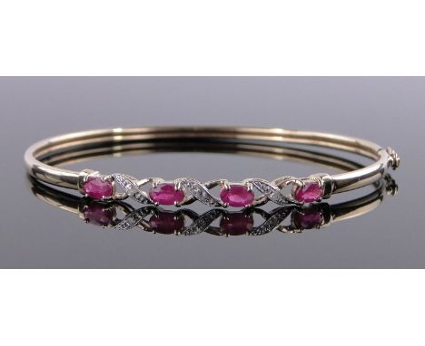 A 9 ct gold ruby & diamond set hinged bangle