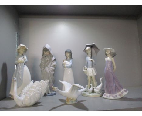 A group of three Nao and two Lladro porcelain figurines, along with a Lladro model of a swan and a goose with wings outstretc