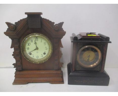 A Victorian black and brown marble cased mantel clock, and a carved walnut cased mantel clockLocation: 