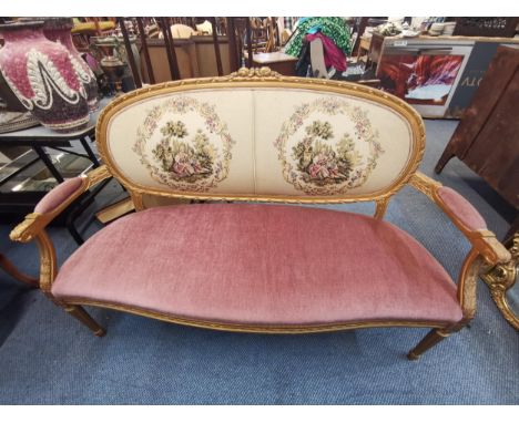 A 20th century French Louis XVI style gilt wood sofa with tapestry backrest and velour seat and arm rests, raised on reeded t