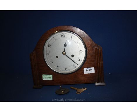 A wooden cased Enfield mantle Clock with key and pendulum.