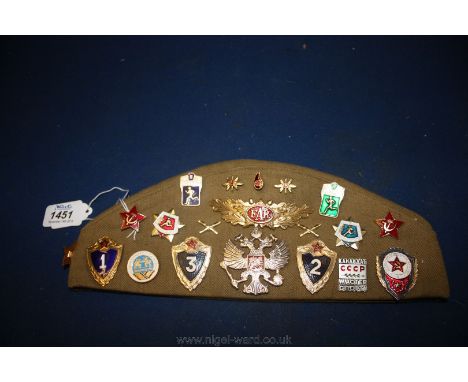 A Russian Cap with 20 enamel badges.