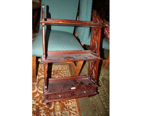 A Chippendale Chinese style reproduction set of Wall Shelves, with three tiers, pierced fret cut sides and two lower drawers,
