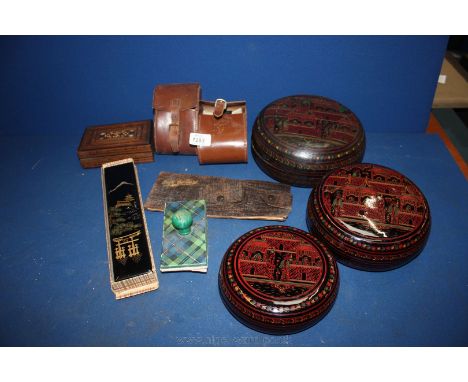 A graduated set of papier mache Boxes decorated in oriental pattern, papier mache chopstick holder and two pairs of chopstick