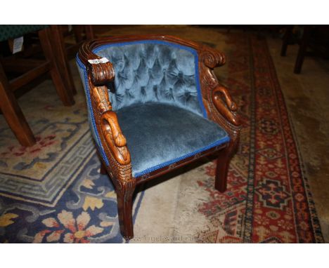 A 19th century style child's Tub Chair, having carved show frame with stylized acanthus scrolls and swans, standing o sabre t