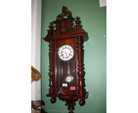A Vienna style Wall Clock with key.