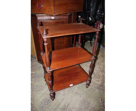 A late 19th c. Mahogany three tier Etagere having finial tops, three slender rectangular shelves separated by turned supports