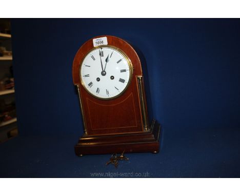 A Mantle Clock with wooden inlaid case and two brass columns, with key.