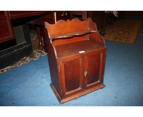 A small Oak Cupboard with fret-cut top and shelf.