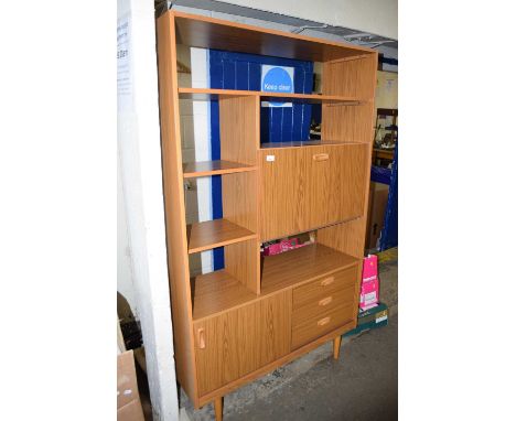 A retro teak finish shelf unit with drinks cabinet section and drawer and cupboard base
