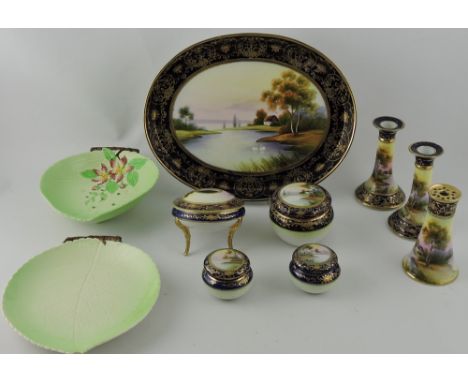 An early 20th century Noritake dressing table set, decorated with a cottage in a riverside landscape, comprising oval tray, t