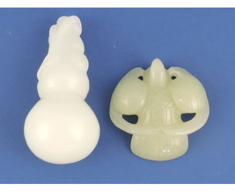 A carved jade pendant in the form of a bird, W. 5.5cm; together with a jade carving of a lotus fruit. (2)