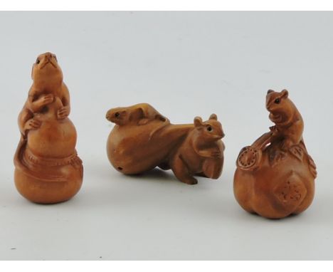 Three carved hardwood netsuke, each formed as a mouse with food, largest H. 6.5cm.
