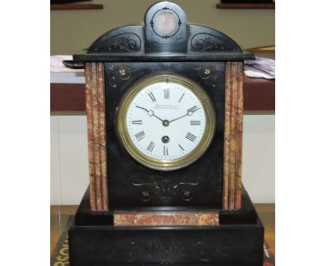 A late 19th French black slate, rouge marble mantel clock with circular white enamel dial marked Roman numerals, H. 33cm.