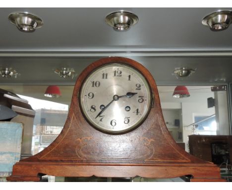 A 20th century mahogany mantle clock, the silvered dial set out in Arabic numerals, the mechanism striking a gong, H. 27cm; t