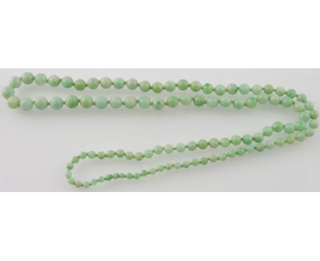 A graduated jade bead necklace, L. 78cm.