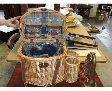 A wicker picnic basket, together with a military brass and copper bugle.