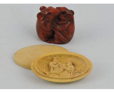 A carved hardwood netsuke of two entwinned mice, W. 4.5cm; together with an oval box opening to reveal an erotic scene. (2).