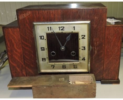 An Art Deco style oak eight day mantel clock and boxed bone dominoes.