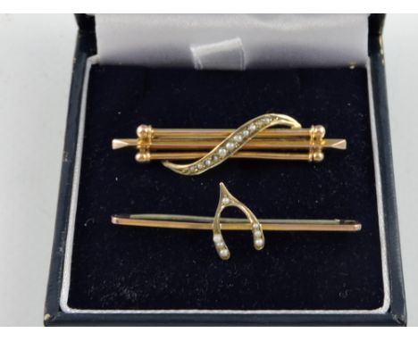 A yellow metal bar brooch, with a band of graduated seed pearls, marked 9C; together with a similar 'wish bone' brooch; total
