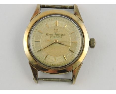 A Girard-Perregaux gyromatic gentleman's gold plated wristwatch head with champagne dial and baton numerals.