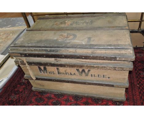 A large Victorian canvas covered wood bound travelling trunk, once the property of the actress Miss Lilla Wilde, sold with tw