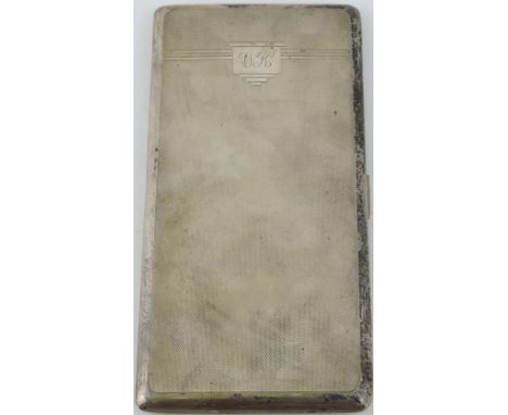 A George VI engine-turned rectangular silver cigarette case, with interior presentation inscription, 8ozt.