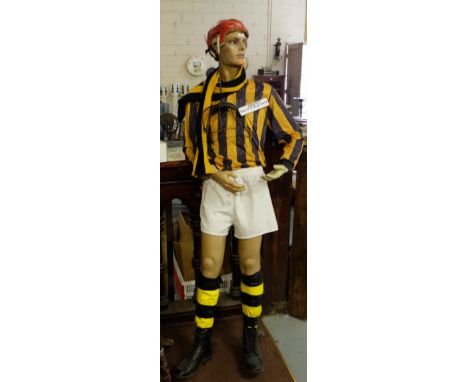 Kilkenny Hurler Mannequin, wearing Kilkenny Jersey, socks, scarf and red helmet, signed “Pat Coady St. Mullins and Carlow”