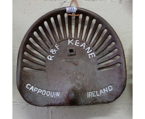 Cast Iron Tractor Seat, stamped “R.F. Keane”, Cappoquin, Waterford, painted brown with white lettering (1)