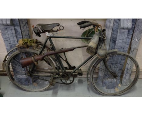 Old Army Bicycle from Kilkenny 1929, painted green with Dunlop seat & old single barrel rifle on side, painted green, with wa