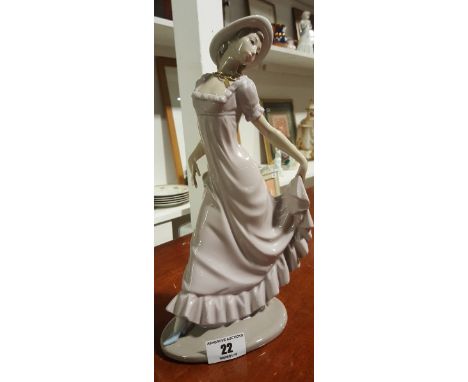 A Large Porcelain Nao Figure of a Girl with pink frilled dress and blue shoes. 30cm.