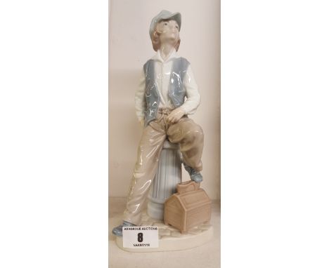 A Nao Porcelain Figure of a Shoe Shine Boy.