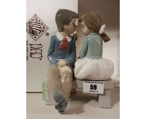 A Boxed Nao Figure - Young Boy & Girl on a Bench.