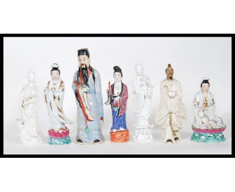 A group of 20th Century Chinese and Japanese ceramic figures to include a blanc de chine immortal holding a lotus flower rais