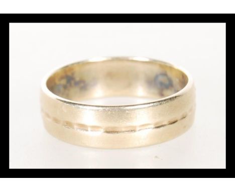 A mid 20th Century hallmarked 9ct gold band ring, having engraving to inner. Hallmarked for London date letter O. Makers mark