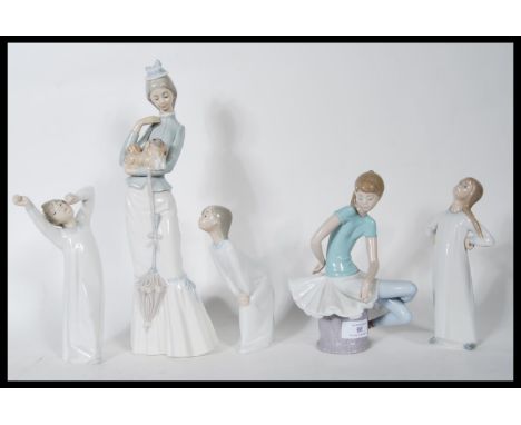 A collection of five ceramic figurines by Lladro to include a tall figurine of a lady holding Pekinese dog 4893, three childr
