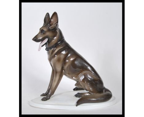A vintage 20th Century Zsolnay ceramic figurine ( stamped&nbsp; 5566 ) modelled as a seated Alsatian / German Shepherd dog. S