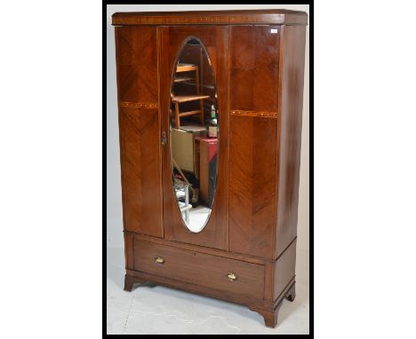 A good Edwardian mahogany and mother of pearl inlaid single wardrobe having plinth drawer base being raised on bracket feet. 