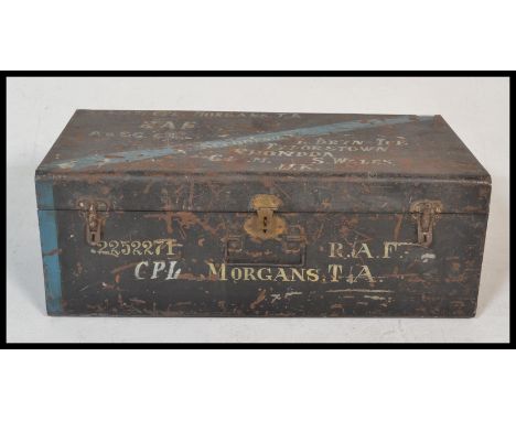 An early 20th Century ebonised tin military steamer trunk, hinged lid with lock and clasps to the front, retailer stamp to th