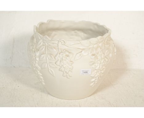 A 20th Century Antique style ceramic jardiniere / planter, glazed white body, having floral and leaf decoration to bulbus bod
