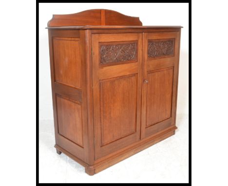 A 19th Century Victorian sideboard / buffet, gallery back over flared top, panel doors with carved grape and vine panel to to