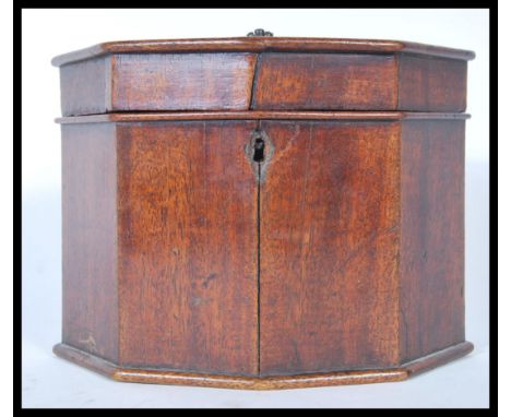A 19th Century Georgian mahogany tea caddy in octagonal form having a hinged lid opening to reveal a fitted interior. Complet